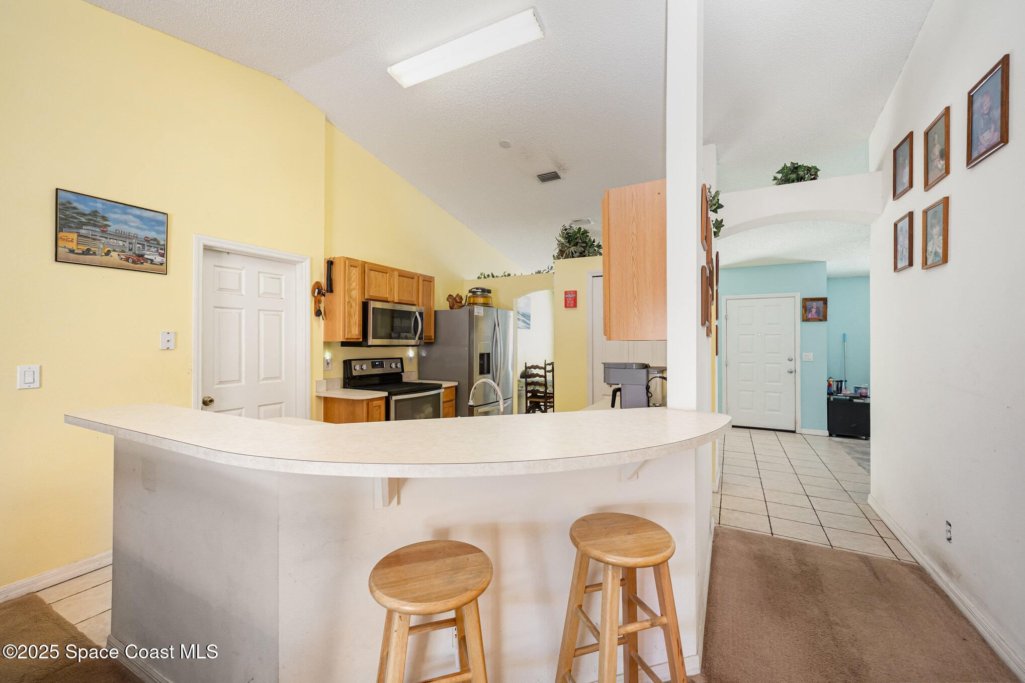 6170 Clearfield Avenue Cocoa, FL 32927 - Photo 7 of 24 a kitchen with stainless steel appliances a refrigerator and microwave