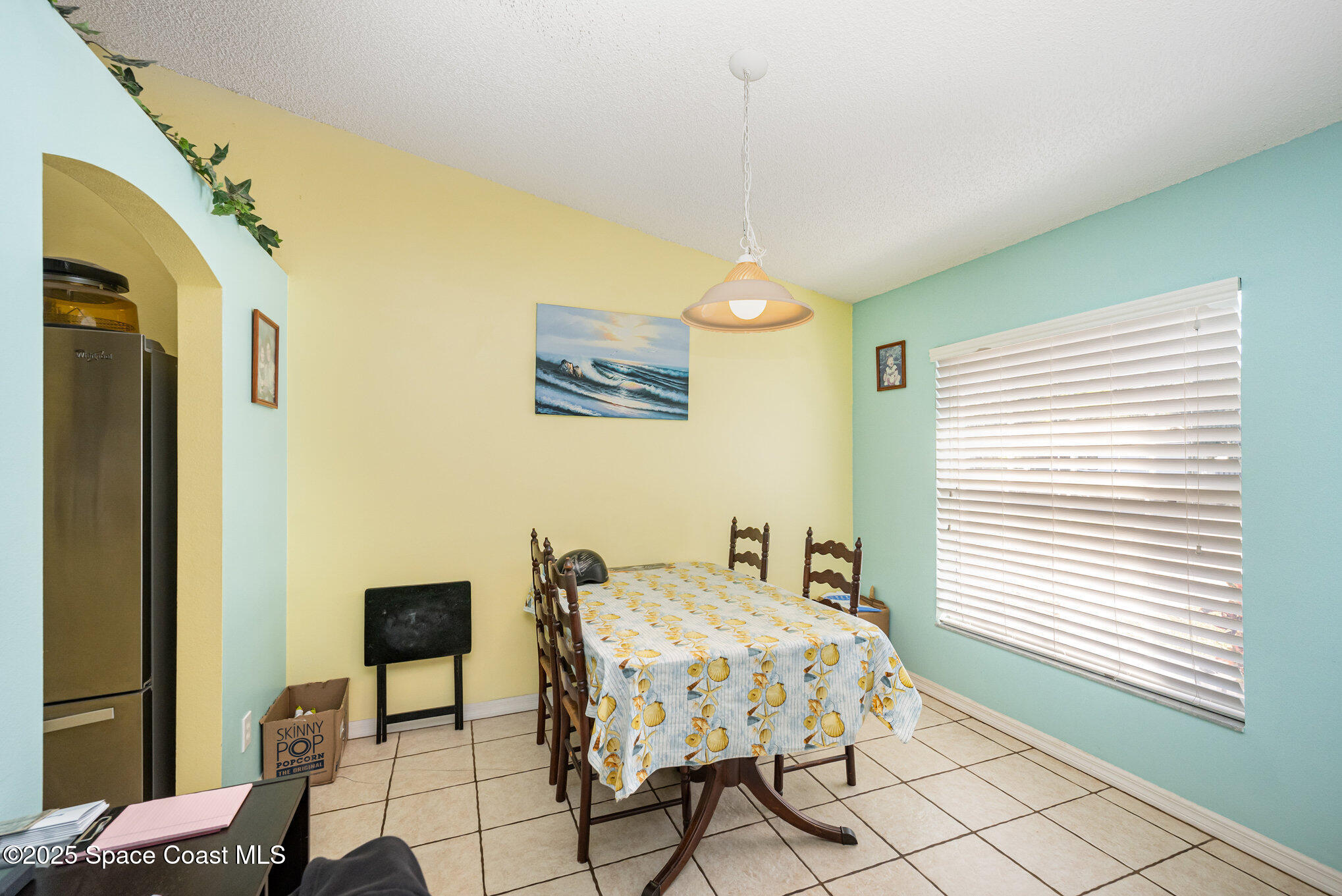 6170 Clearfield Avenue Cocoa, FL 32927 - Photo 9 of 24 a bedroom with a bed and a chandelier