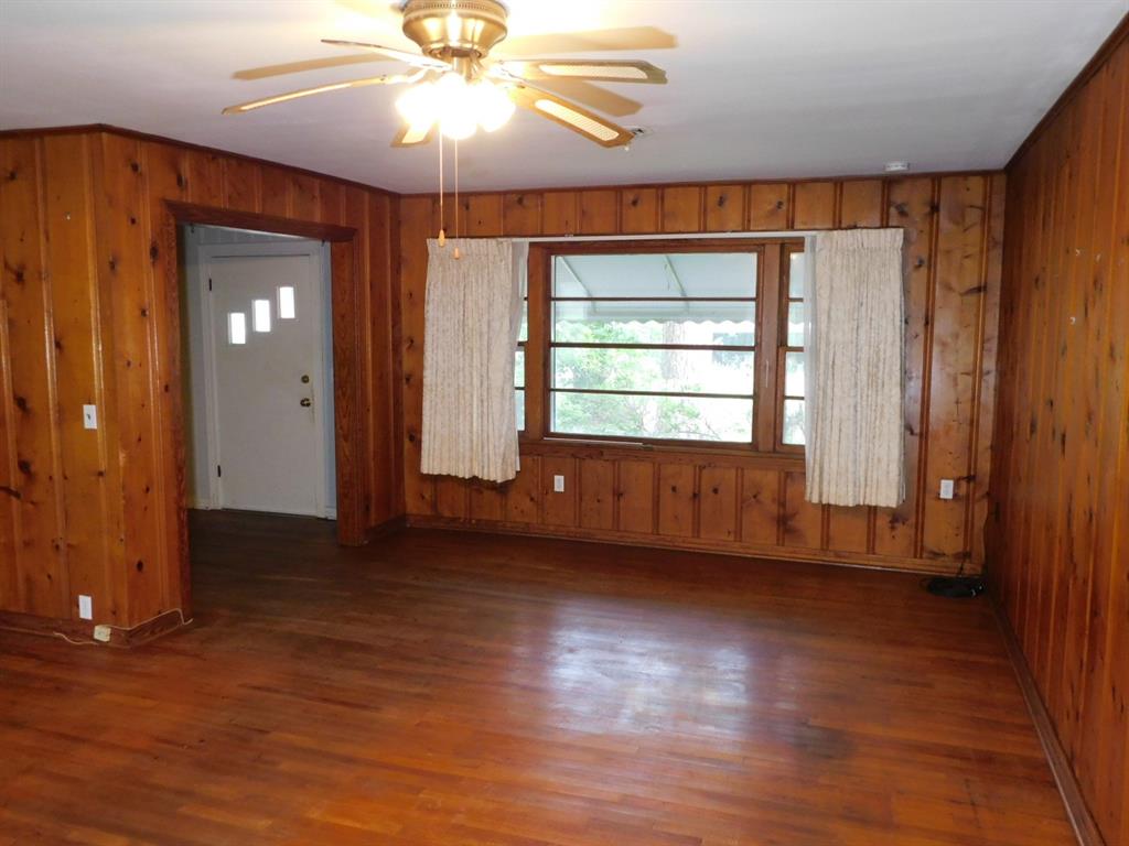 24044 Highway 157 Springhill, LA 71075 - Photo 22 of 40 a view of an empty room with window and wooden floor