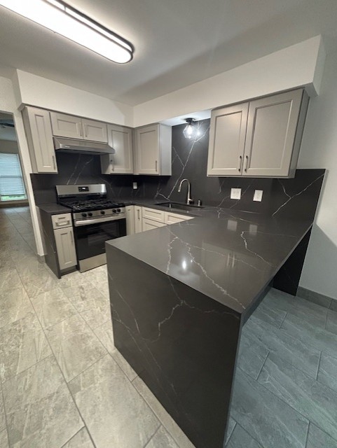 11801 Argonne Forest Trail, Unit B Austin, TX 78759 - Photo 11 of 12 a kitchen with stainless steel appliances a stove a sink and a refrigerator