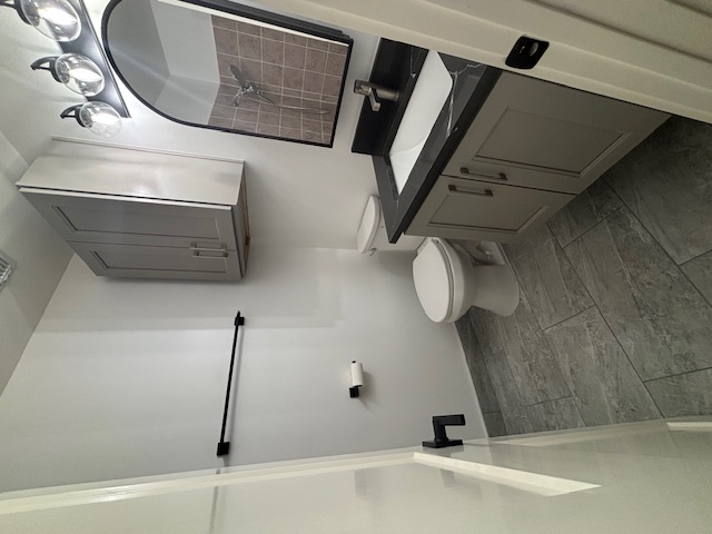 11801 Argonne Forest Trail, Unit B Austin, TX 78759 - Photo 5 of 12 a bathroom with a sink a toilet and shower