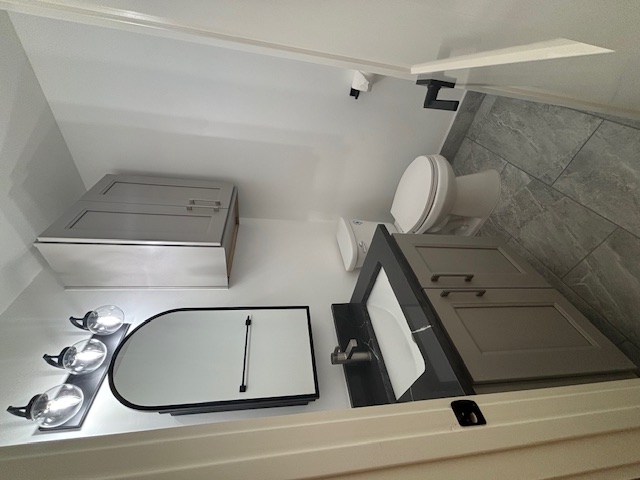 11801 Argonne Forest Trail, Unit B Austin, TX 78759 - Photo 7 of 12 a bathroom with a toilet sink and mirror