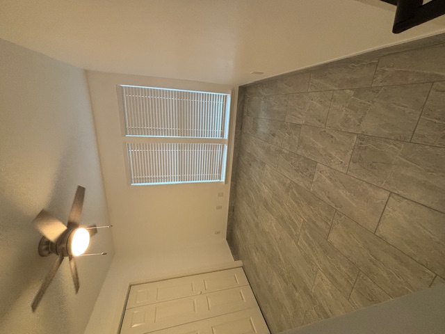 11801 Argonne Forest Trail, Unit B Austin, TX 78759 - Photo 8 of 12 en empty room with windows and fan