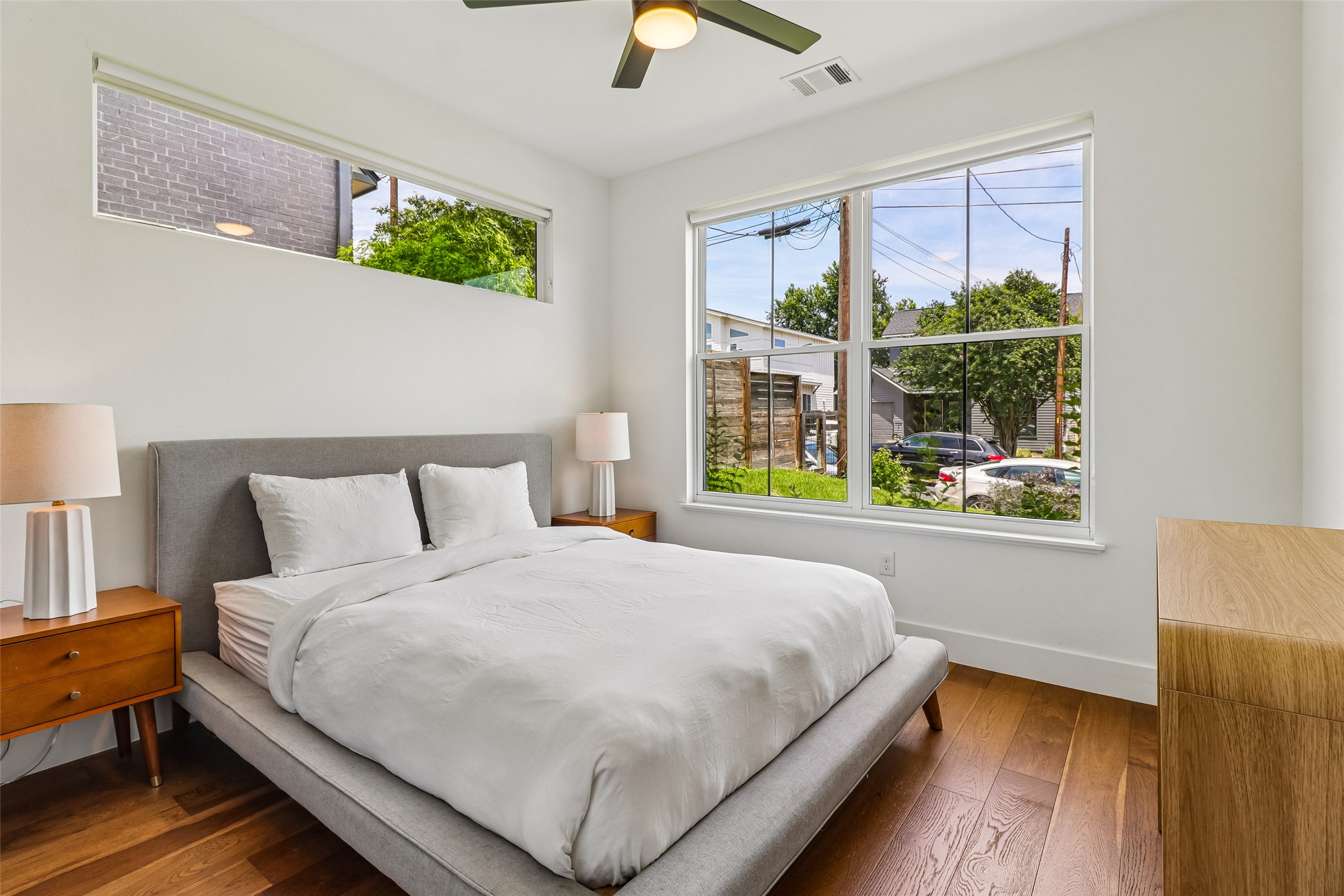 1706 Perez Street, Unit 1 Austin, TX 78721 - Photo 17 of 36 Hardwood floors and generous windows elevate this spacious, naturally illuminated bedroom.