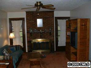 6219 Old Meadow Road Charlotte, NC 28227 - Photo 2 of 8 a living room with furniture and a fireplace