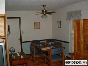 6219 Old Meadow Road Charlotte, NC 28227 - Photo 4 of 8 a view of a dining room with furniture and a chandelier fan