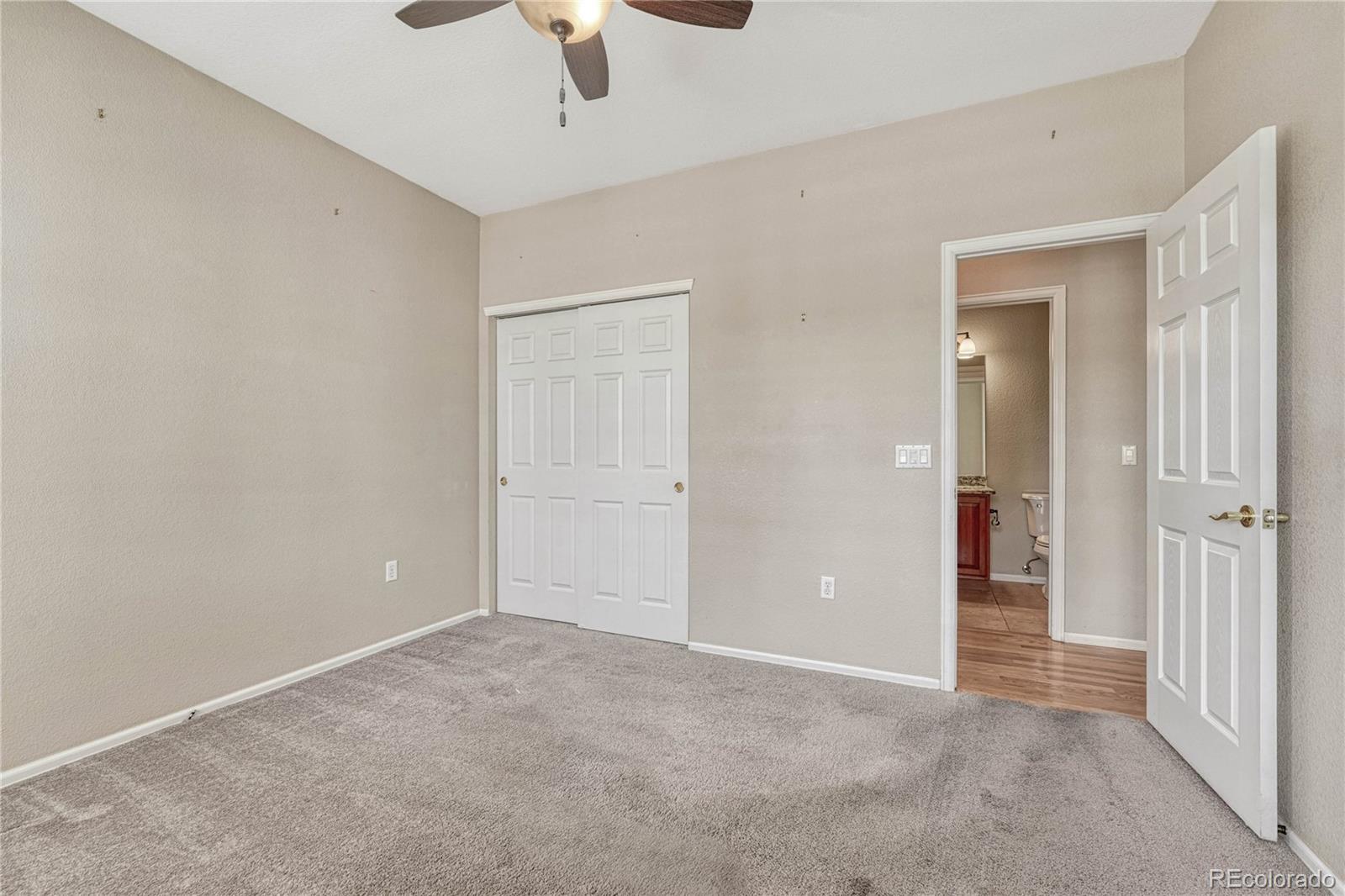 8107 South Catawba Court Aurora, CO 80016 - Photo 24 of 46 an empty room with ceiling fan and window