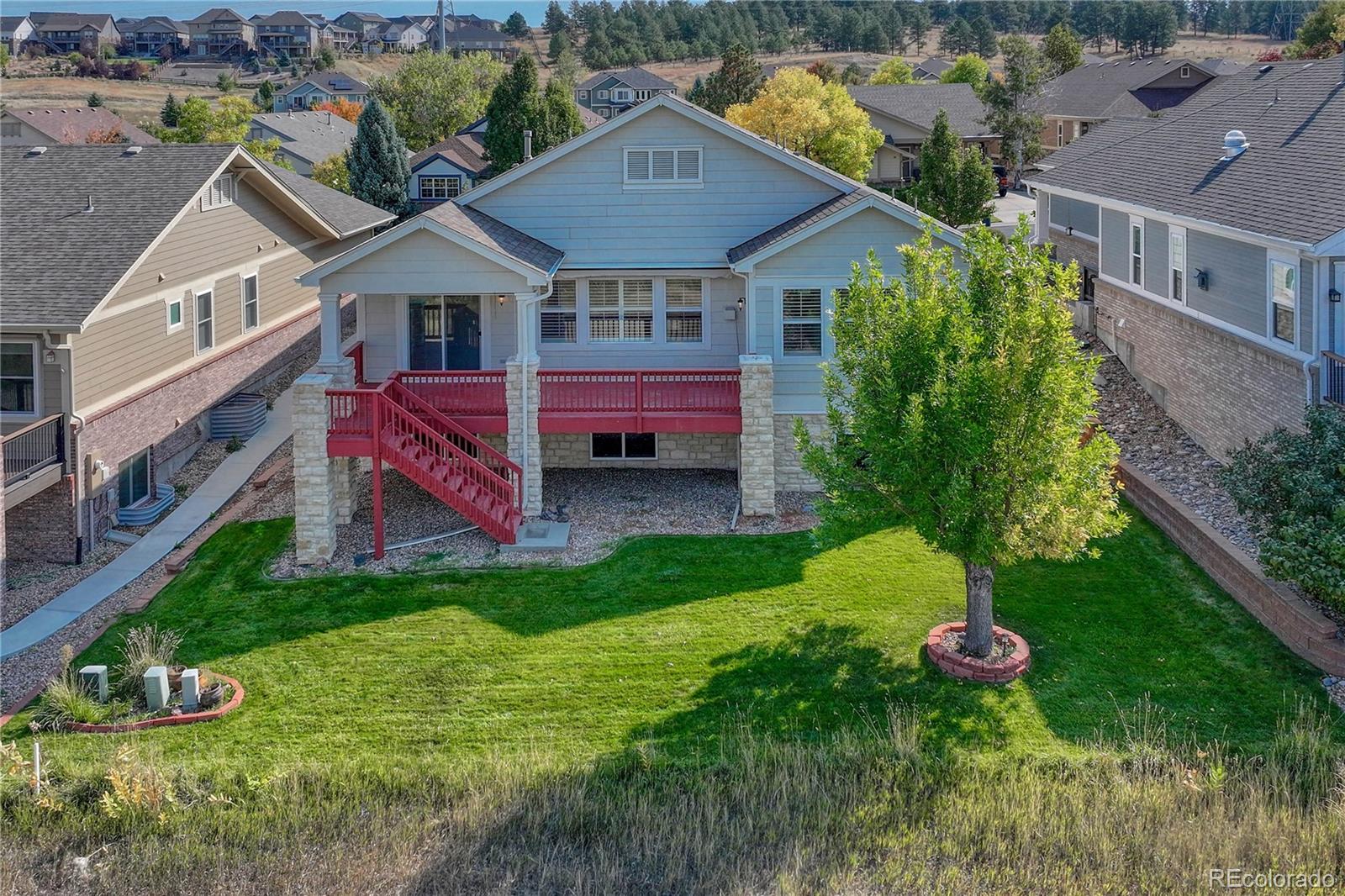 8107 South Catawba Court Aurora, CO 80016 - Photo 40 of 46 a front view of a house with a garden and plants