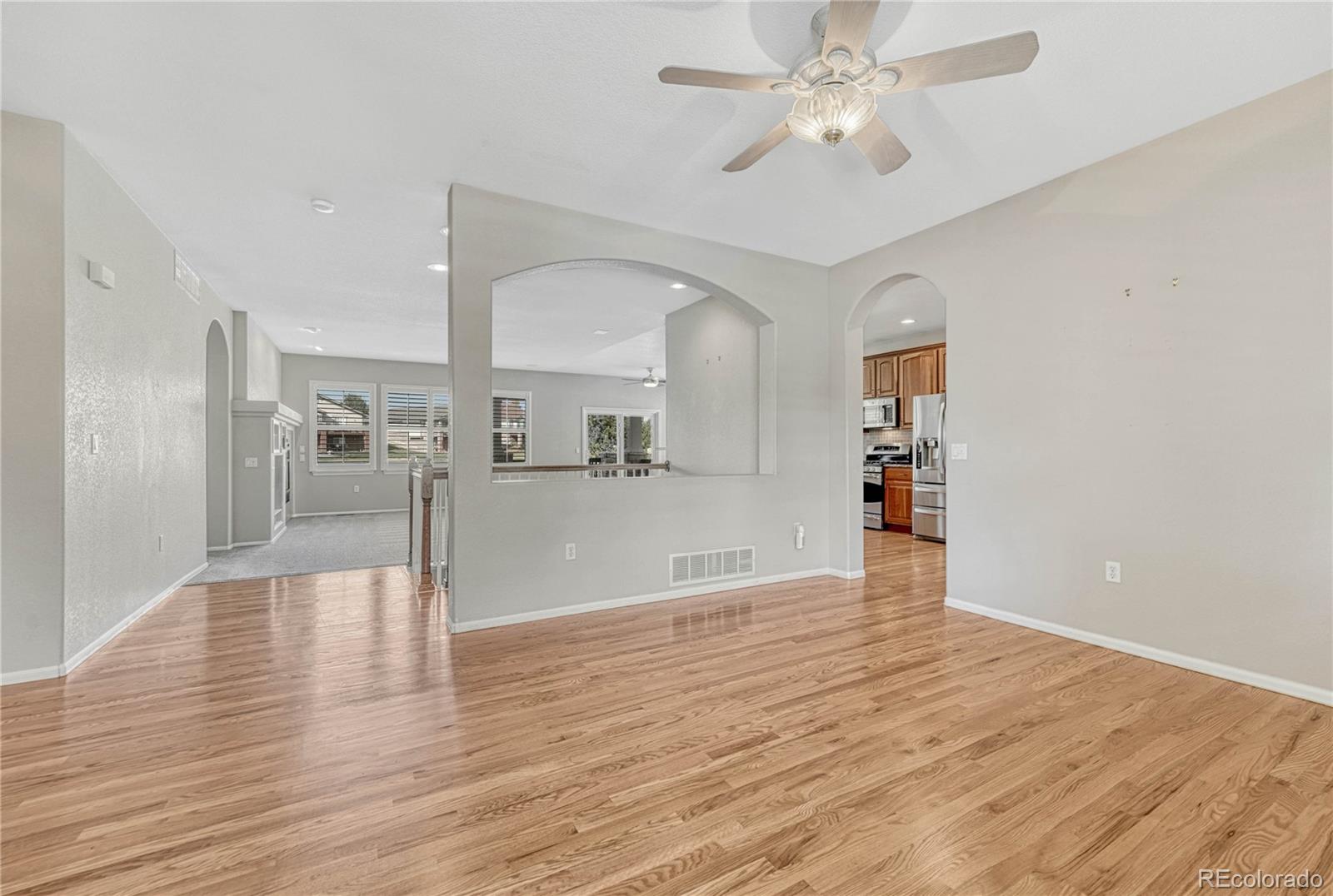 8107 South Catawba Court Aurora, CO 80016 - Photo 8 of 46 a view of a kitchen with wooden floor and a kitchen space with a sink