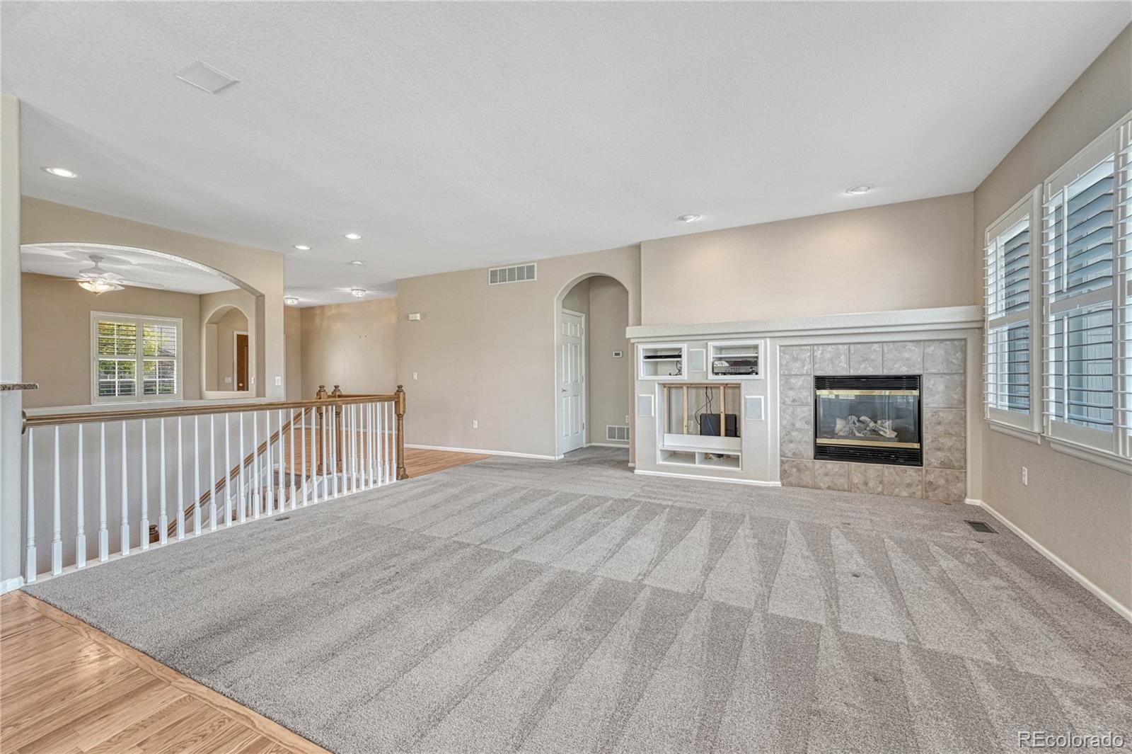 8107 South Catawba Court Aurora, CO 80016 - Photo 10 of 46 a view of a livingroom with wooden floor and windows