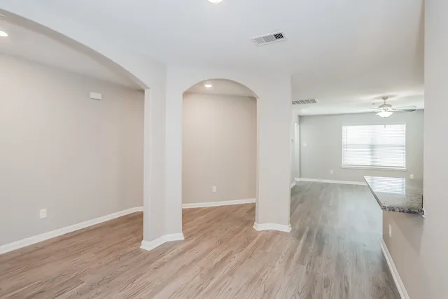 wooden floor in an empty room with a window