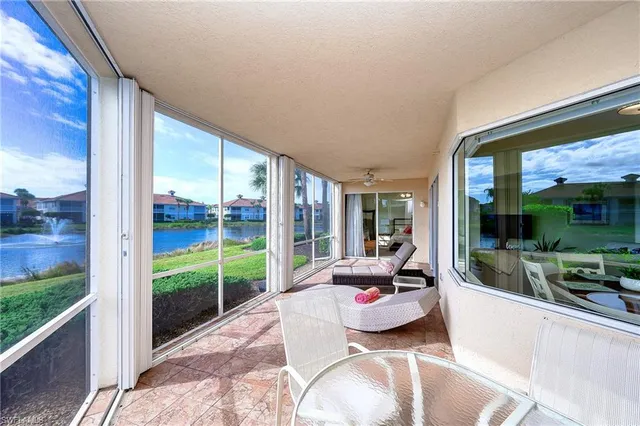 a room with furniture and large windows