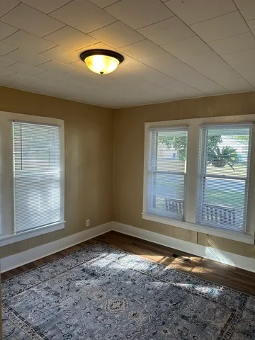 a view of a room window and wooden floor