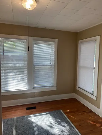 a room with window and a rug