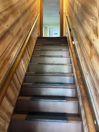 a view of a livingroom with wooden floor and furniture