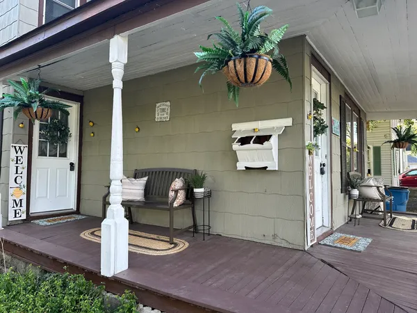 a front view of a house with outdoor seating