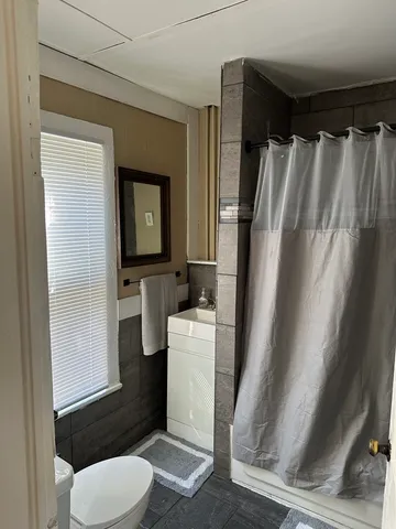 a room with wooden floor and a window