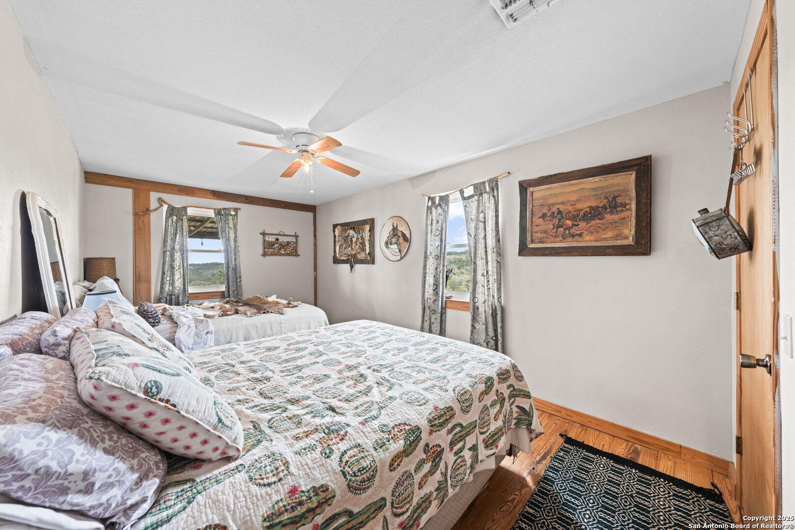 943 Stoneleigh Road Center Point, TX 78010 - Photo 11 of 36 a bedroom with a large bed and a window