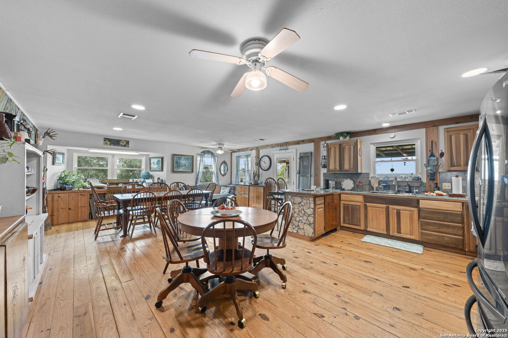 943 Stoneleigh Road Center Point, TX 78010 - Photo 12 of 36 a view of a dining room with furniture window and wooden floor
