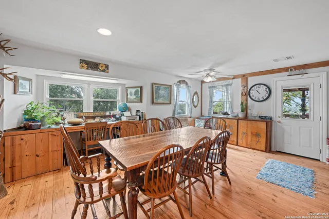 a view of a dining room and livingroom with furniture window and wooden floor