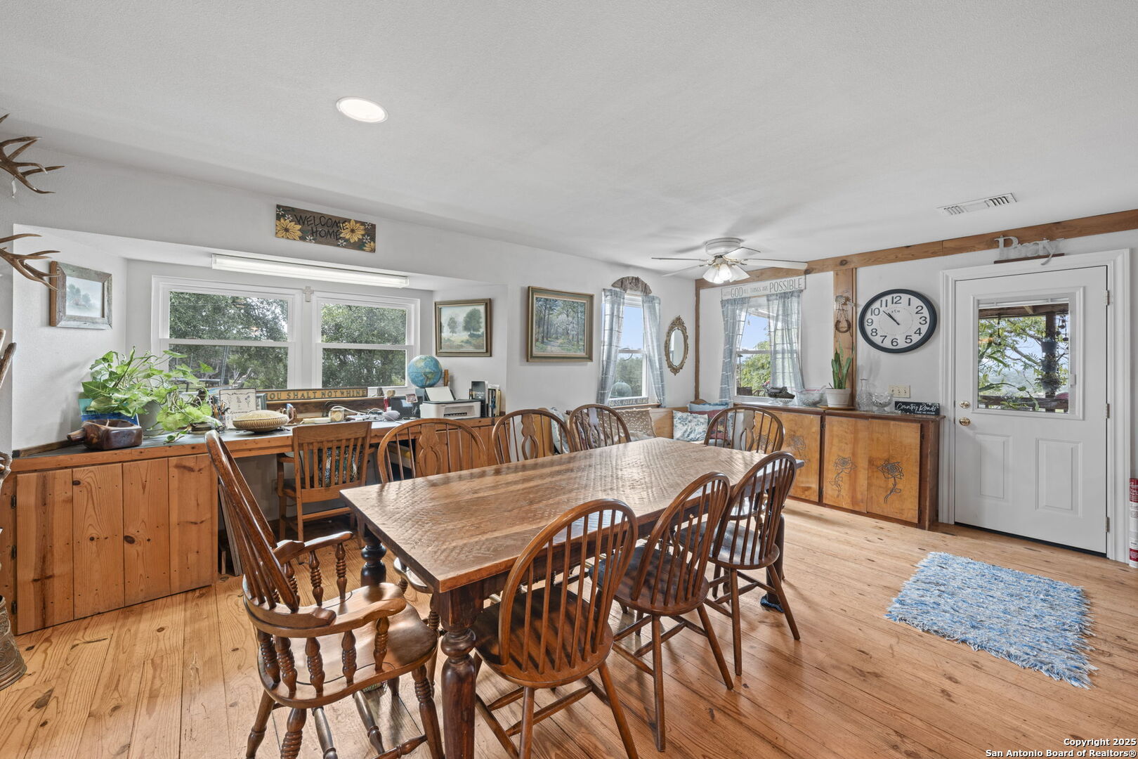 943 Stoneleigh Road Center Point, TX 78010 - Photo 15 of 36 a view of a dining room and livingroom with furniture window and wooden floor