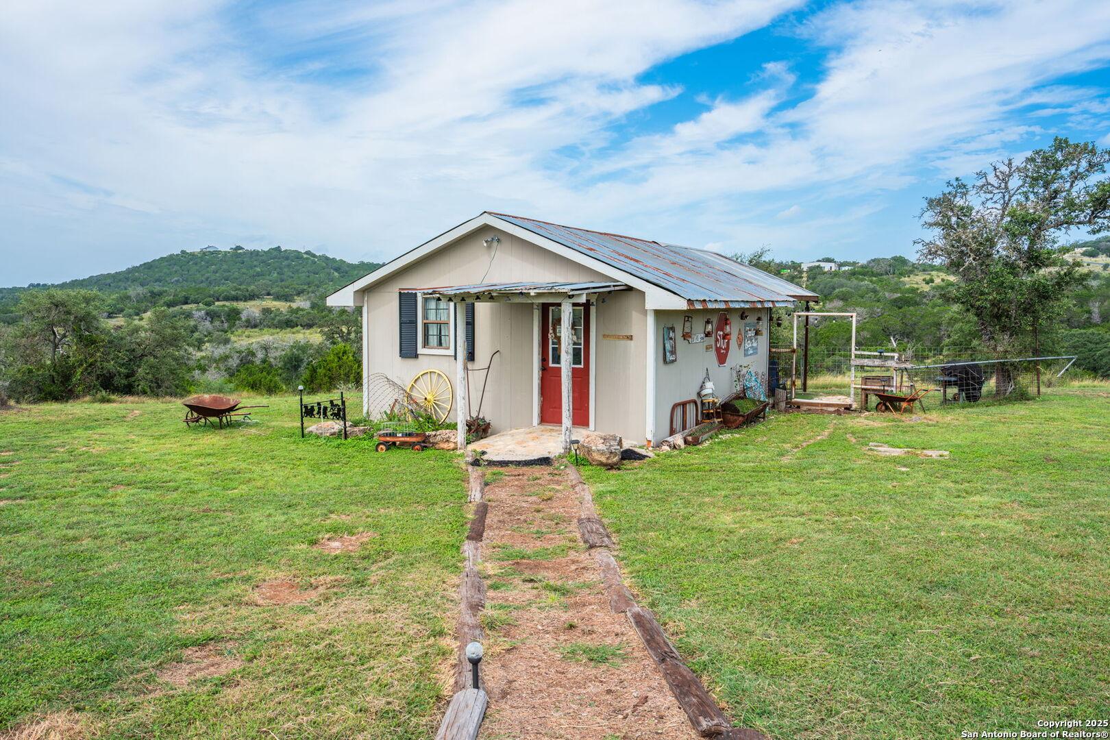 943 Stoneleigh Road Center Point, TX 78010 - Photo 18 of 36 a view of a house with backyard and garden