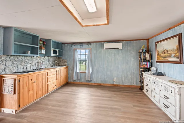 a kitchen with granite countertop a sink stove and cabinets