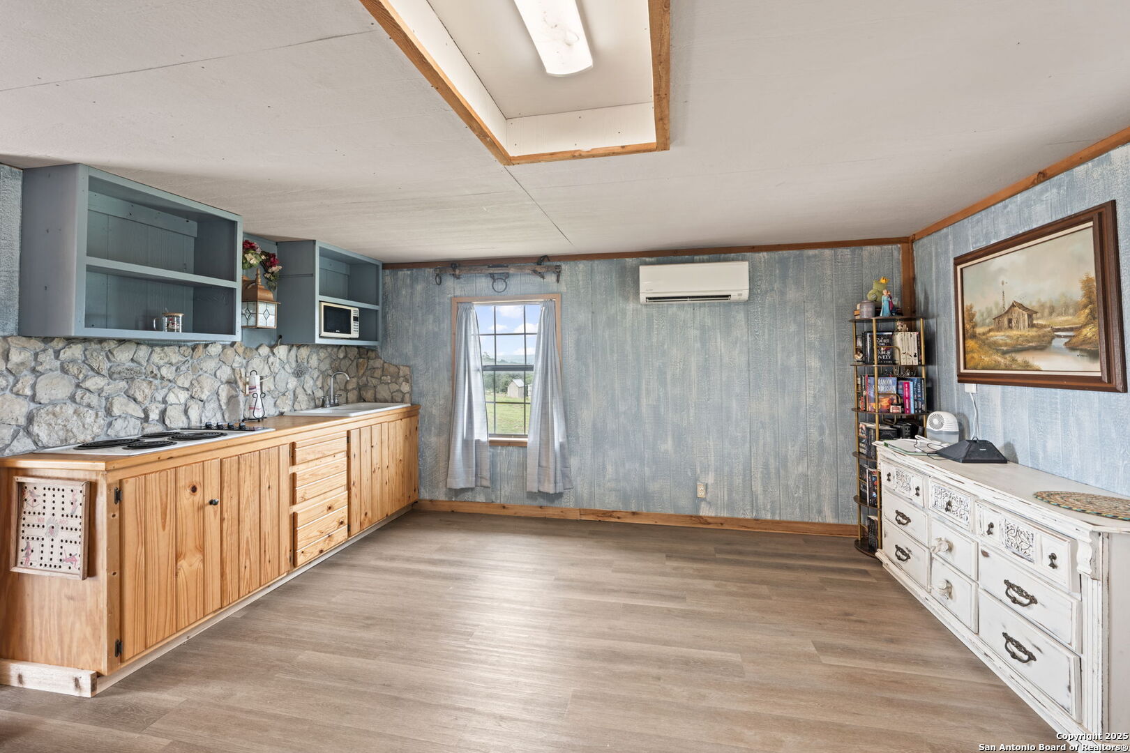 943 Stoneleigh Road Center Point, TX 78010 - Photo 20 of 36 a kitchen with granite countertop a sink stove and cabinets