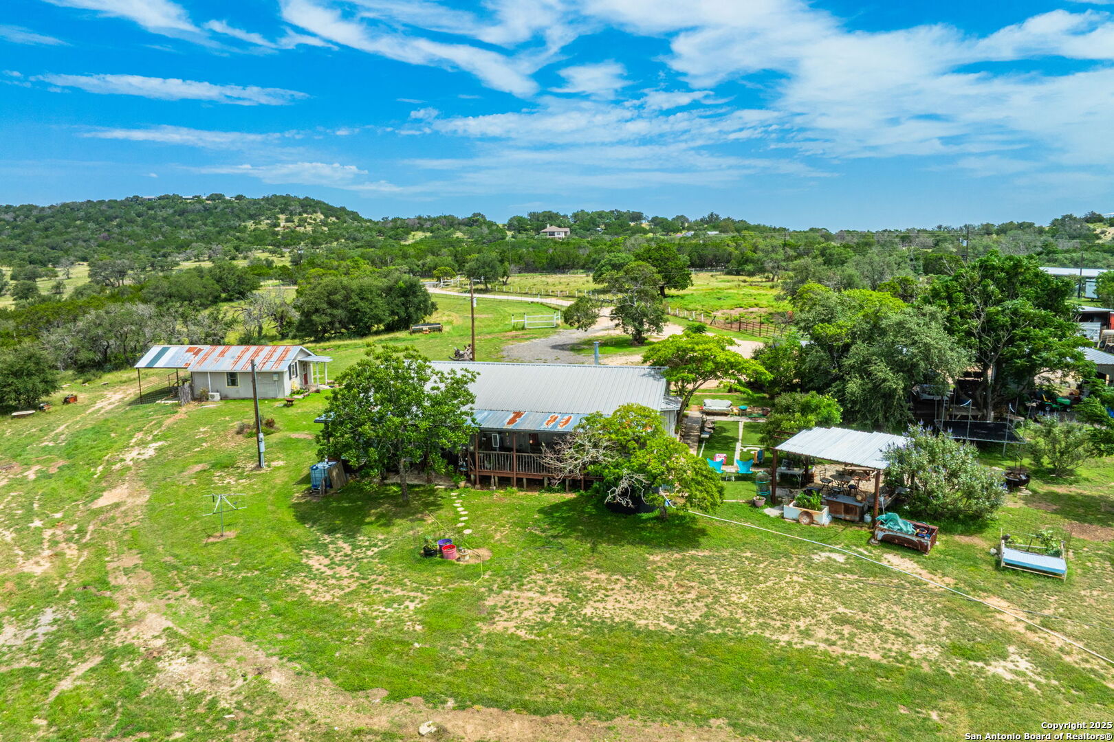 943 Stoneleigh Road Center Point, TX 78010 - Photo 3 of 36 a view of a garden with lawn chairs