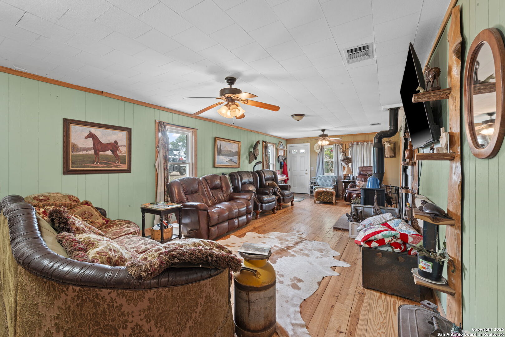 943 Stoneleigh Road Center Point, TX 78010 - Photo 4 of 36 a living room with furniture and a flat screen tv