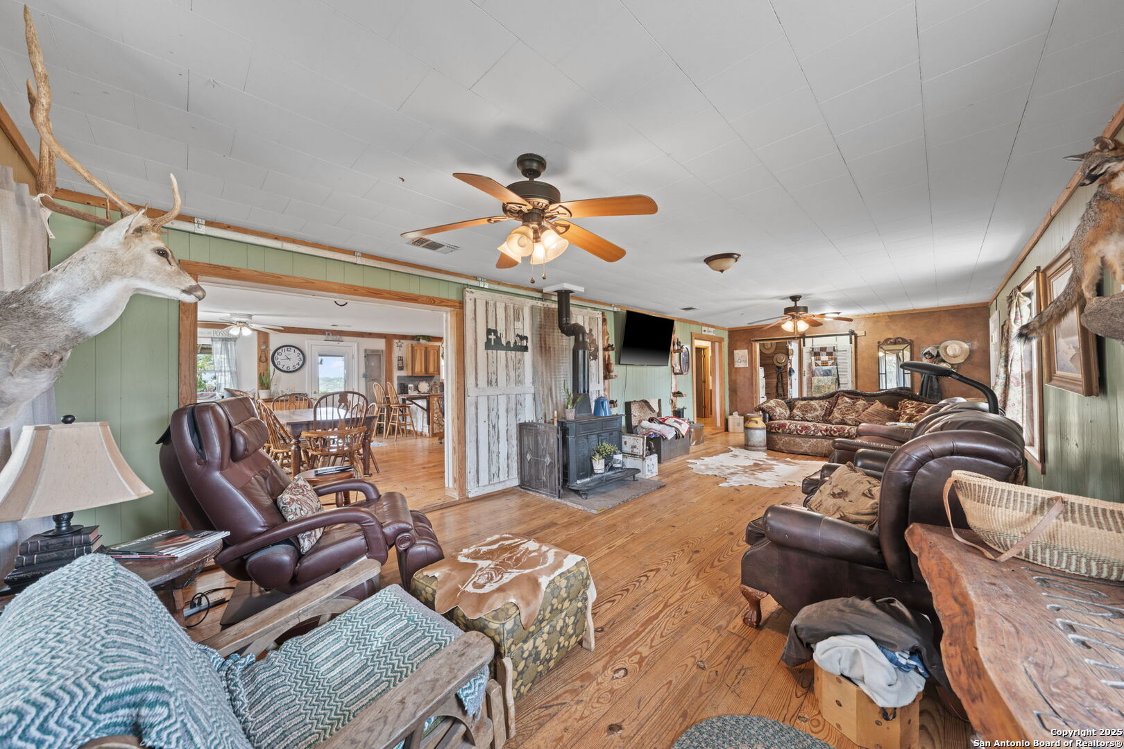 943 Stoneleigh Road Center Point, TX 78010 - Photo 6 of 36 a living room with furniture ceiling fan and a rug