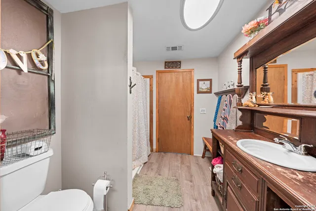 a bathroom with a sink mirror vanity and toilet