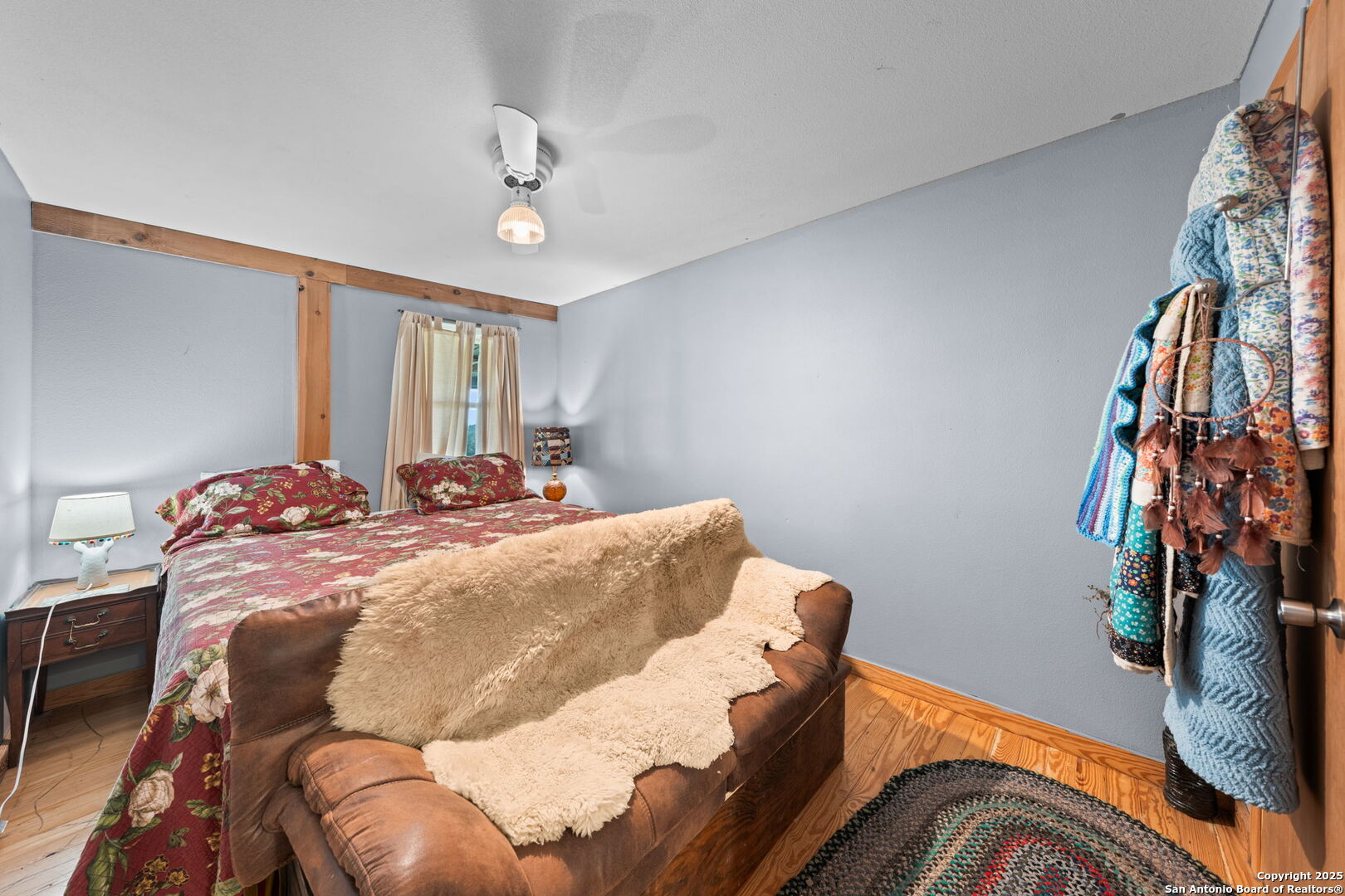 943 Stoneleigh Road Center Point, TX 78010 - Photo 10 of 36 a bed sitting in a bedroom next to a lamp