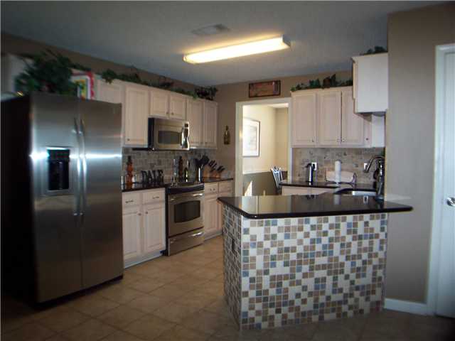 1303 River Ridge Drive Collierville, TN 38017 - Photo 3 of 12 Fantastic kitchen w/new everything...quartz countertops, stainless appliances, convection oven, tile floor, tiled backsplash, tiled breakfast bar, brushed nickle faucets...