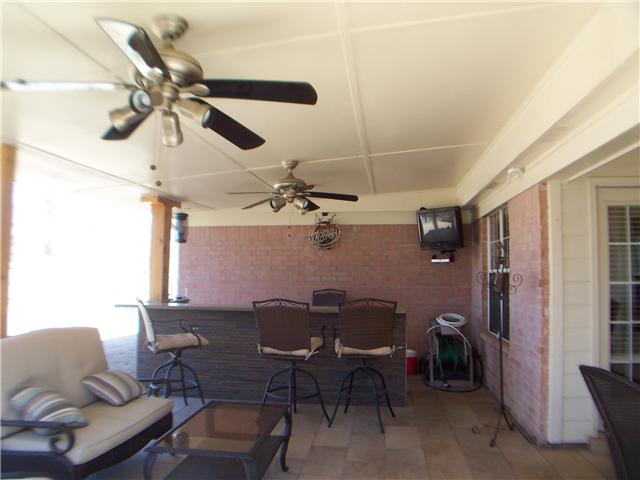 1303 River Ridge Drive Collierville, TN 38017 - Photo 10 of 12 Check out this large covered patio with tiled floor, bar, fridge, ceiling fans, surround sound, and its even wired for TV.