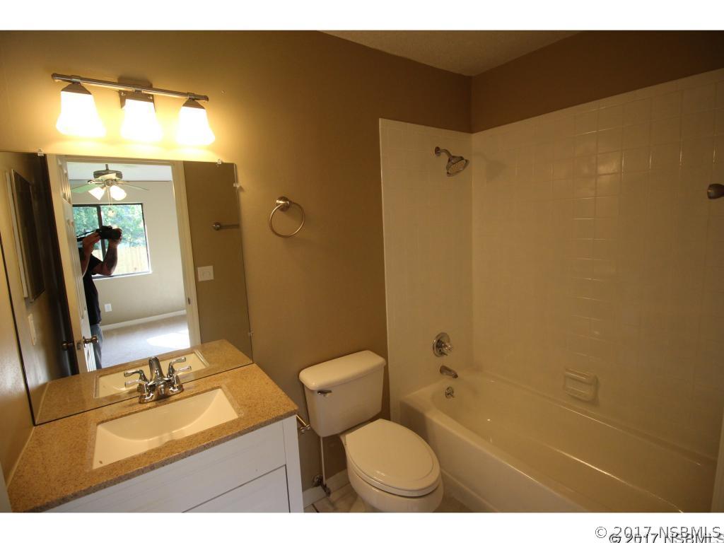 2007 Orange Tree Drive Edgewater, FL 32141 - Photo 12 of 23 a bathroom with a granite countertop sink toilet and shower