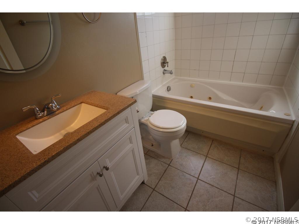 2007 Orange Tree Drive Edgewater, FL 32141 - Photo 16 of 23 a bathroom with a sink a toilet and bathtub