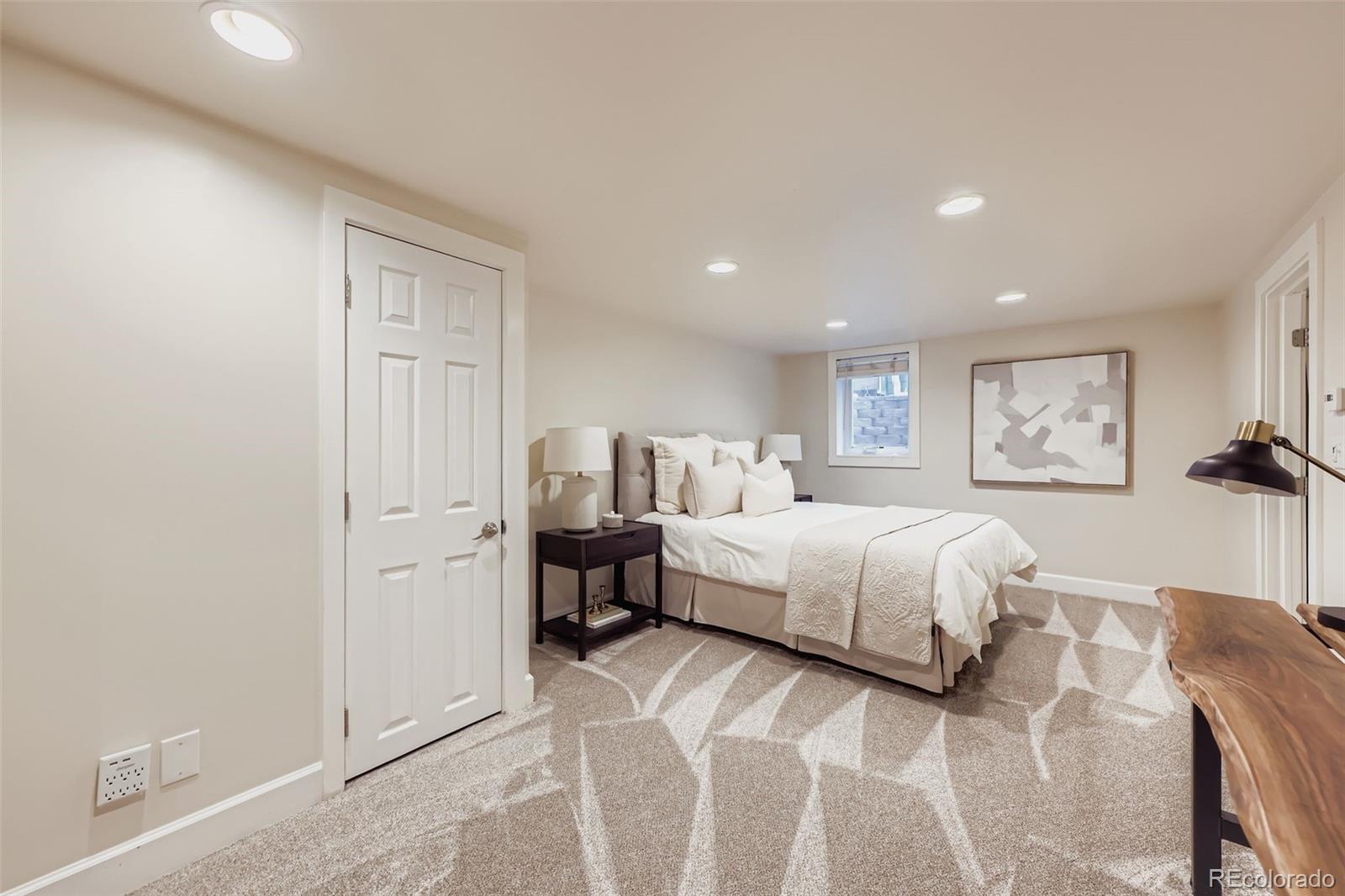 120 Gilbert Street Castle Rock, CO 80104 - Photo 17 of 25 a spacious bedroom with a bed and a lamp
