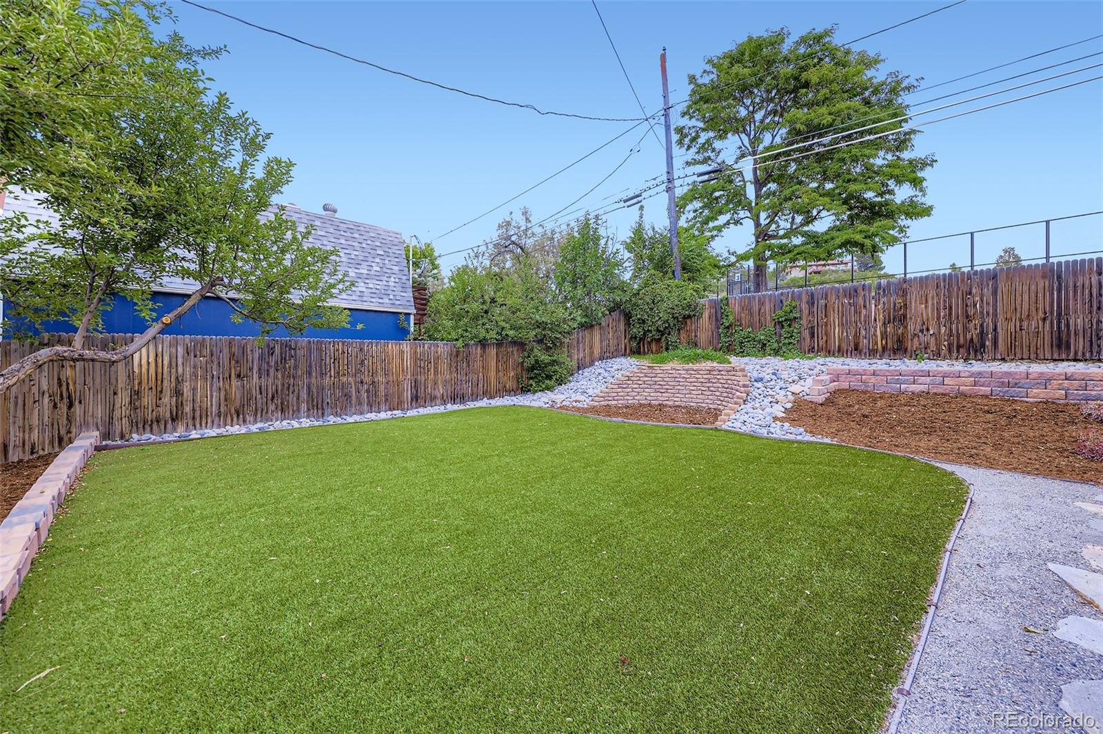 120 Gilbert Street Castle Rock, CO 80104 - Photo 22 of 25 a view of a backyard with wooden fence