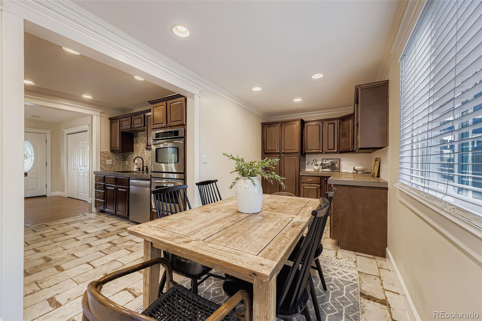 120 Gilbert Street Castle Rock, CO 80104 - Photo 7 of 25 a kitchen with a table and chairs in it