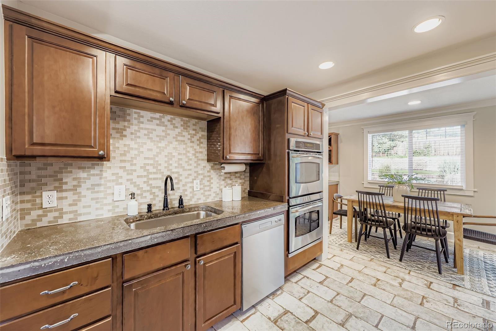 120 Gilbert Street Castle Rock, CO 80104 - Photo 10 of 25 a kitchen with stainless steel appliances granite countertop a sink and cabinets