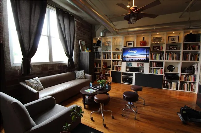 a living room with furniture a window and a flat screen tv