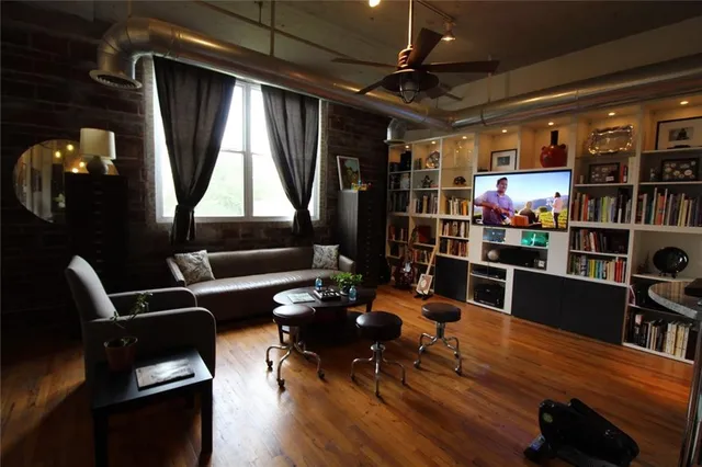 a living room with lots of furniture and a book shelf