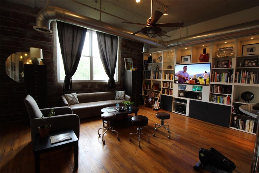 172 Haynes Street Southwest, Unit 208 Atlanta, GA 30313 - Photo 11 of 30 a living room with lots of furniture and a book shelf