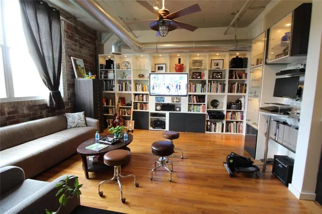 a living room with furniture or kitchen view and a wooden floor