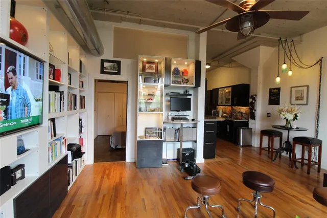 a living room with lots of furniture and kitchen view