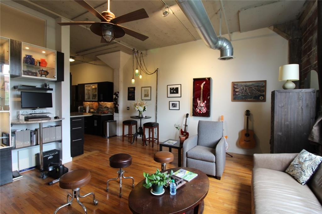 172 Haynes Street Southwest, Unit 208 Atlanta, GA 30313 - Photo 15 of 30 a living room with furniture and a flat screen tv