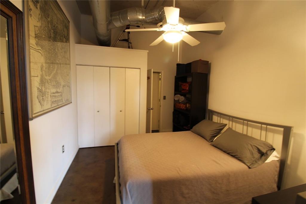 172 Haynes Street Southwest, Unit 208 Atlanta, GA 30313 - Photo 19 of 30 a bedroom with a bed and a chandelier