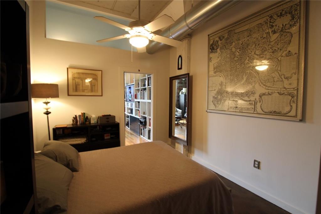 172 Haynes Street Southwest, Unit 208 Atlanta, GA 30313 - Photo 20 of 30 a bedroom with a bed and a chandelier