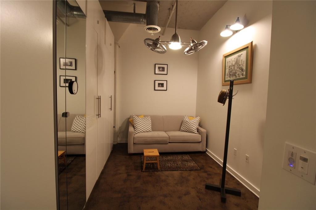 172 Haynes Street Southwest, Unit 208 Atlanta, GA 30313 - Photo 2 of 30 a living room with furniture and a chandelier